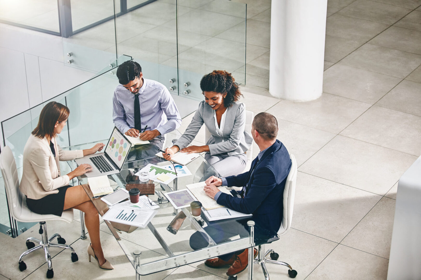 Business meeting with four people at table.