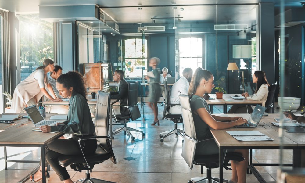 Modern office with people working at desks.
