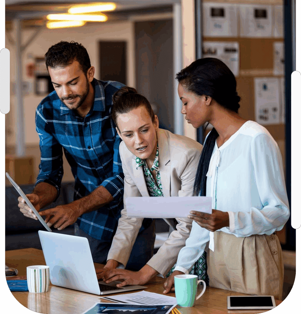 Three colleagues collaborating at a desk.