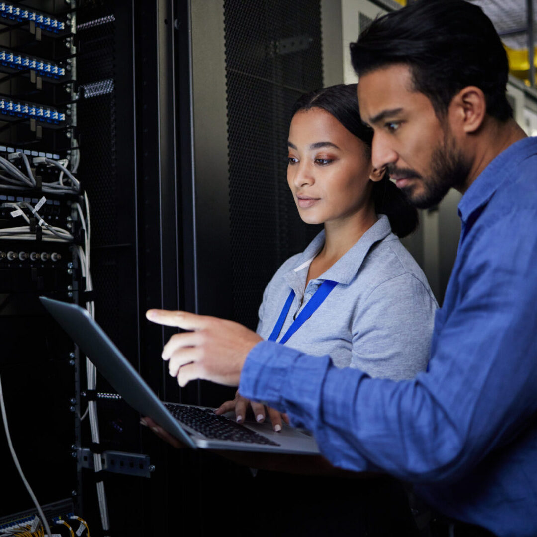 Technicians working in a server room.